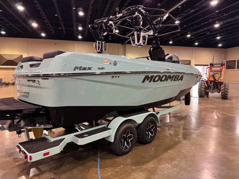 Slide: The Image of 2025 Moomba Max boat on trailer in indoor showroom setting. - 11