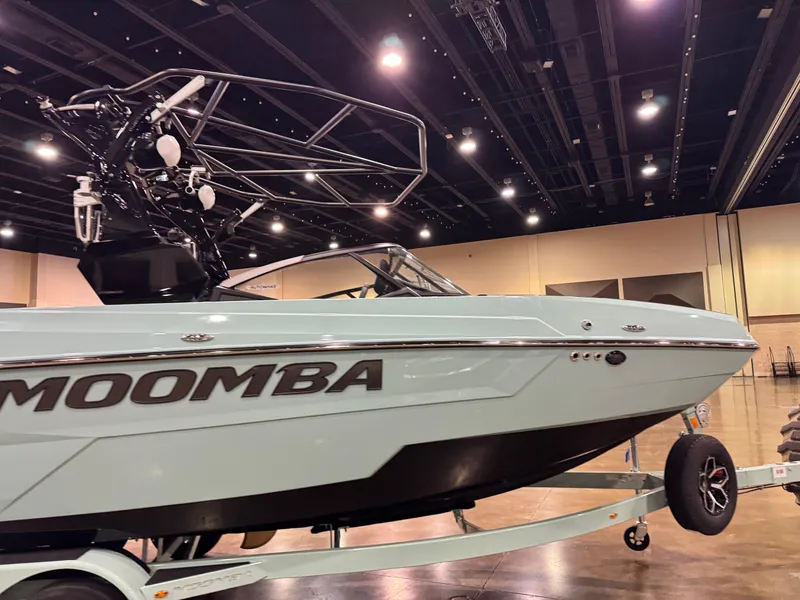 Slide: The Image of 2025 Moomba Max boat on display indoors, showcasing sleek design and modern features. - 13