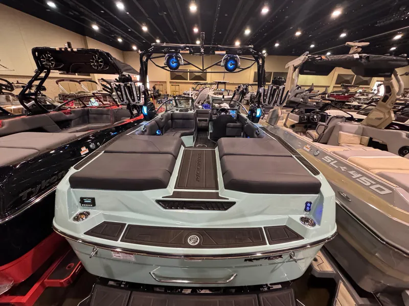 Slide: The Image of 2025 Moomba Max boat displayed at an indoor showroom with luxurious seating and modern design. - 15