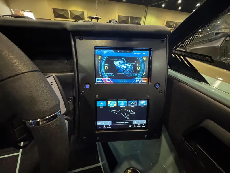 Slide: The Image of 2025 Moomba Max dashboard with dual touchscreens displaying navigation and control settings. - 26