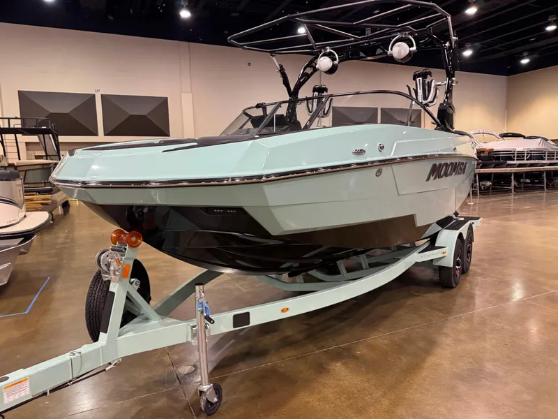 Slide: The Image of 2025 Moomba Max boat on trailer in indoor showroom. - 3