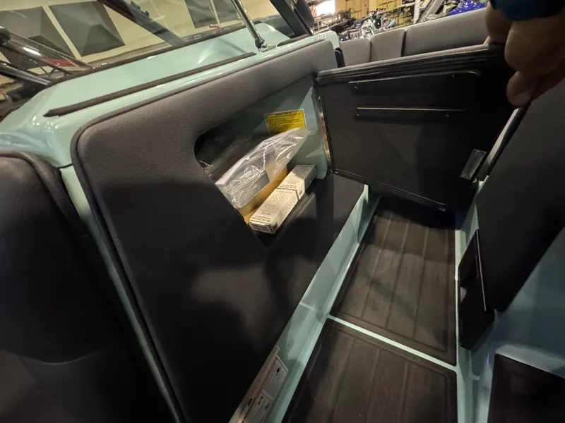 Slide: The Image of 2025 Moomba Max interior storage compartment with open door, showcasing sleek design and functionality. - 30