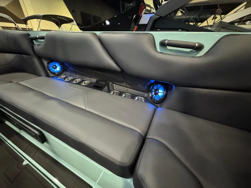 Slide: The Image of 2025 Moomba Max interior with sleek seating, blue LED speakers, and cup holders. - 37
