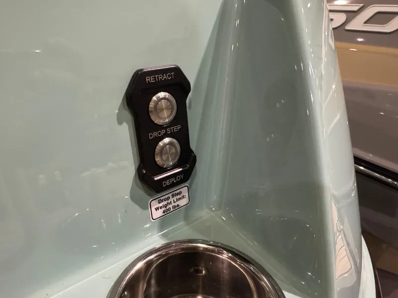 Slide: The Image of Control panel on 2025 Moomba Max boat with retract and deploy buttons. - 48