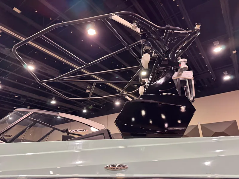 Slide: The Image of 2025 Moomba Max boat with sleek black wakeboard tower, showcased indoors. - 5