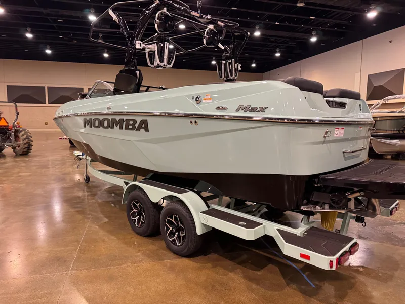 Slide: The Image of 2025 Moomba Max boat on display in an indoor showroom. - 6