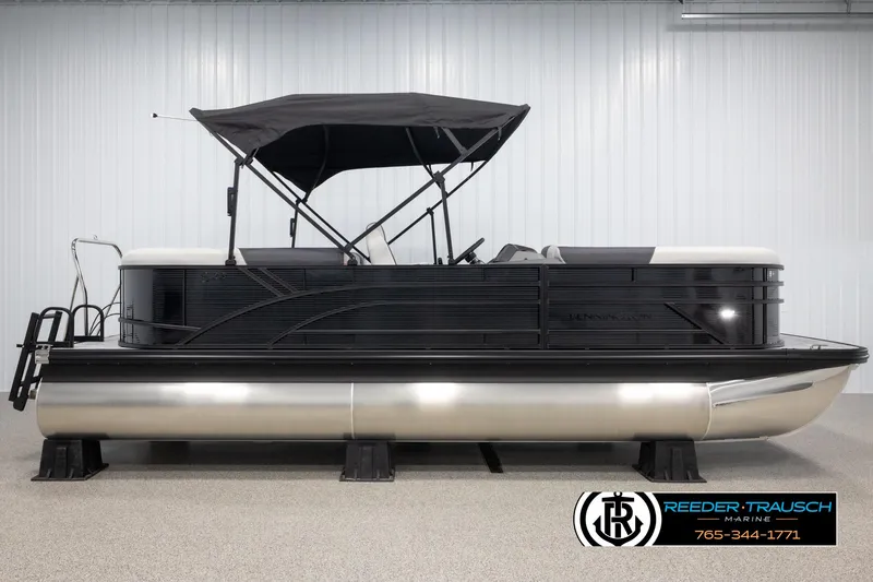 Slide: The Image of 2025 Bennington 22 SSRSE pontoon boat with black canopy in showroom. - 5