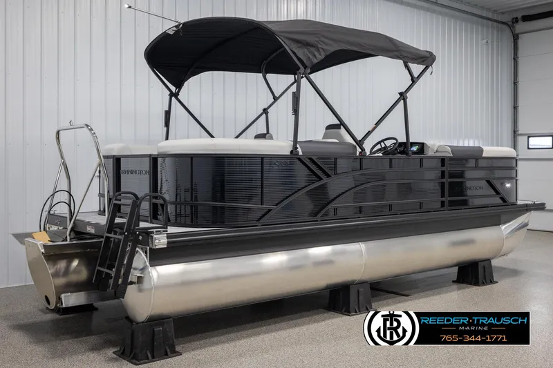 Slide: The Image of 2025 Bennington 22 SSRSE pontoon boat with black canopy in showroom. - 6