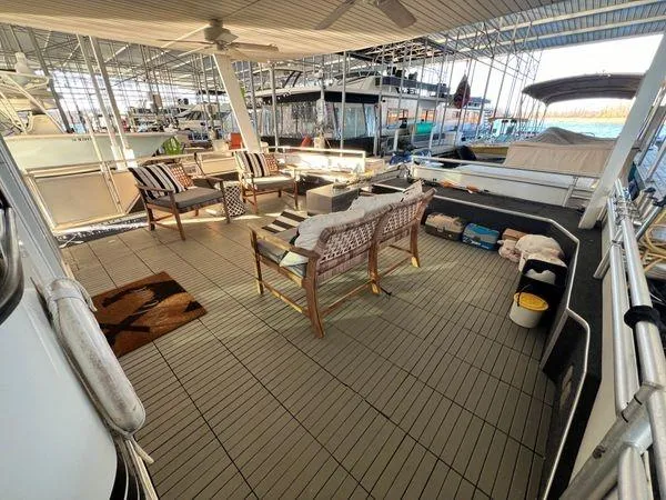 Slide: The Image of Spacious deck of 2005 Sumerset 90x18 houseboat with outdoor seating and marina view. - 10