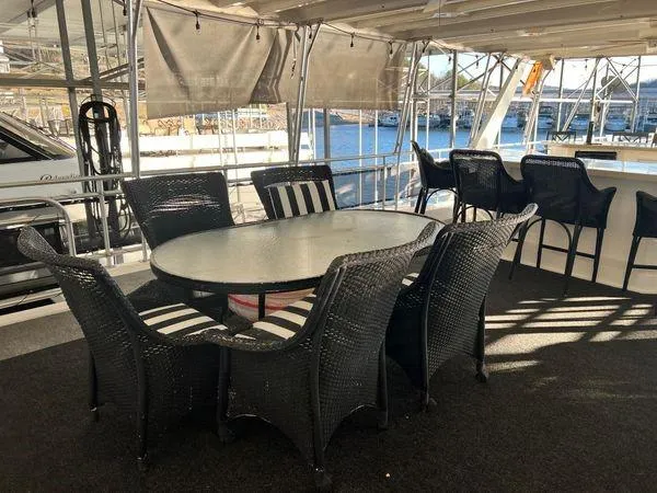 Slide: The Image of Outdoor seating area on 2005 Sumerset 90x18 houseboat with wicker chairs and table. - 12