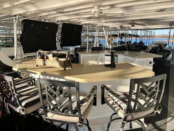 Slide: The Image of Luxurious 2005 Sumerset 90x18 houseboat interior with bar seating and lake view. - 13