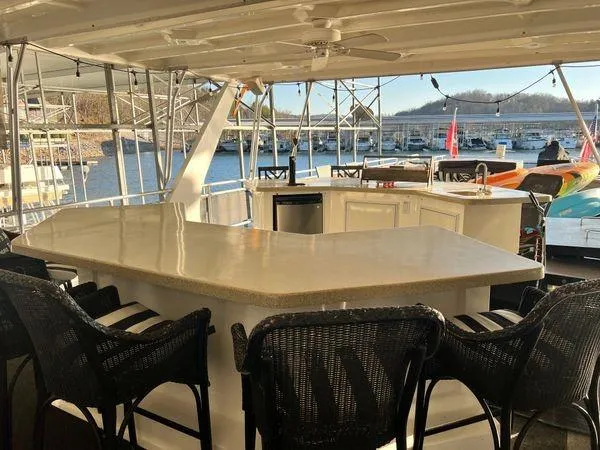 Slide: The Image of Outdoor bar area on 2005 Sumerset 90x18 houseboat with wicker chairs and scenic marina view. - 14