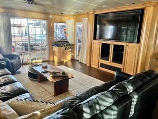 Slide: The Image of Luxurious 2005 Sumerset 90x18 houseboat interior with leather seating and large TV. - 24