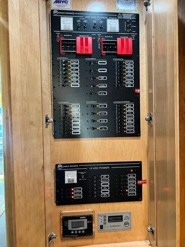 Slide: The Image of Electrical control panel on a 2005 Sumerset 90x18 houseboat, featuring various switches and meters. - 28