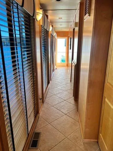 Slide: The Image of Hallway of 2005 Sumerset 90x18 houseboat with tiled floor and wooden paneling. - 32