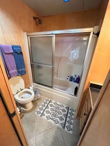 Slide: The Image of Small bathroom in 2005 Sumerset 90x18 houseboat with shower, toilet, and towels. - 37