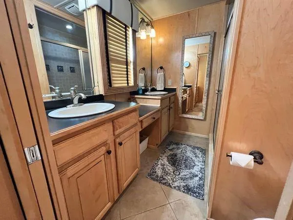 Slide: The Image of Luxurious bathroom in 2005 Sumerset 90x18 houseboat with wooden cabinetry and modern fixtures. - 45
