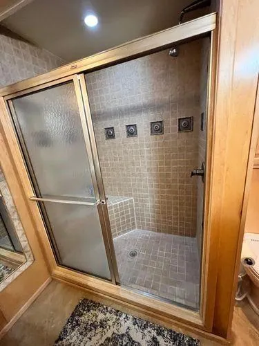 Slide: The Image of Luxurious shower in 2005 Sumerset 90x18 houseboat with tiled walls and sliding glass doors. - 48