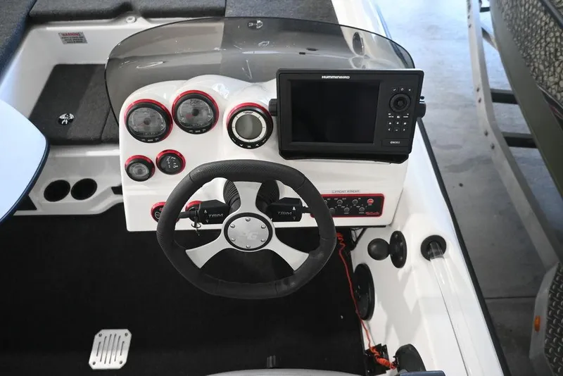 Slide: The Image of 2006 Bass Cat Puma boat dashboard with steering wheel and electronic display. - 10