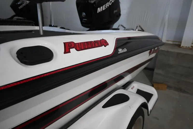 Slide: The Image of 2006 Bass Cat Puma boat with Mercury engine, white and black design. - 4