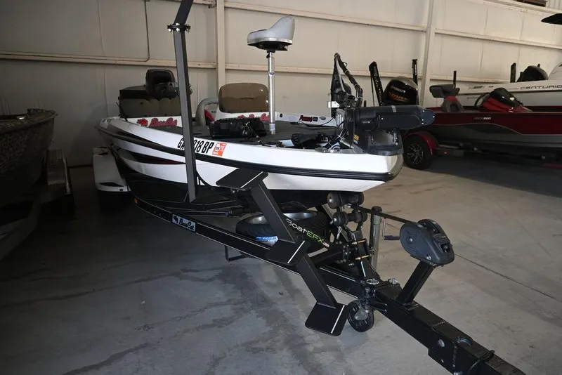 Slide: The Image of 2006 Bass Cat Puma boat in a garage, featuring a sleek design and advanced equipment. - 6