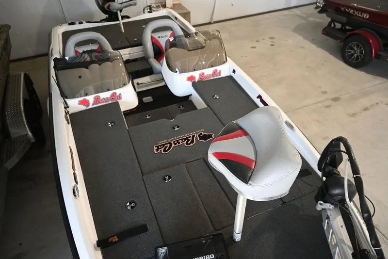 Slide: The Image of 2006 Bass Cat Puma boat interior with seating and storage compartments. - 7