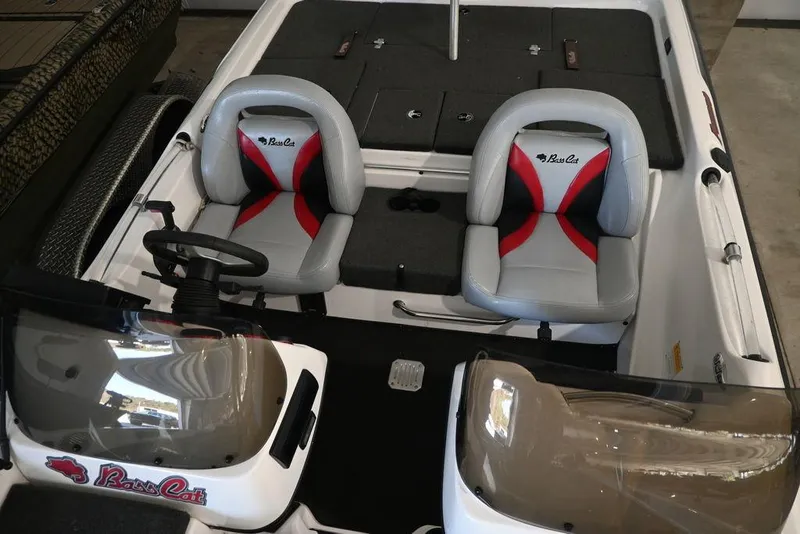 Slide: The Image of 2006 Bass Cat Puma boat interior with dual seats and steering console. - 8