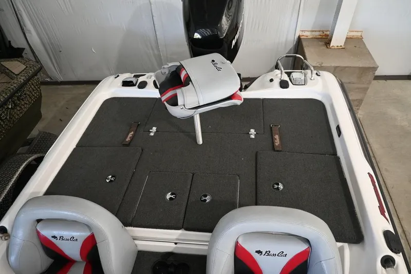 Slide: The Image of 2006 Bass Cat Puma boat interior with seating and storage compartments. - 9