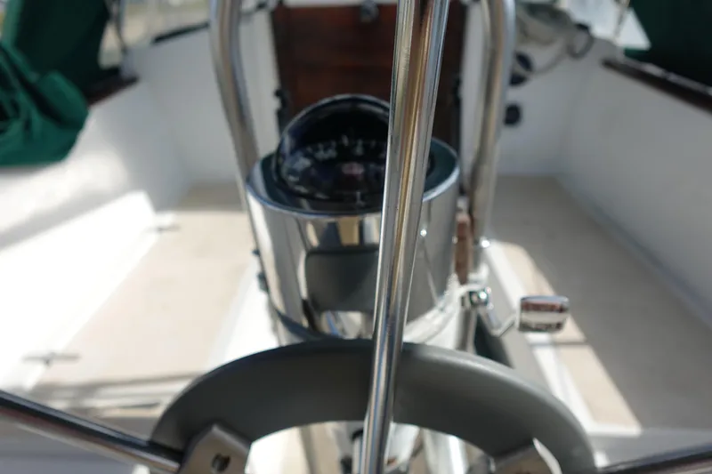 Slide: The Image of 1982 Morgan 383 sailboat cockpit with steering wheel and compass. - 17