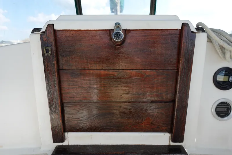 Slide: The Image of 1982 Morgan 383 sailboat wooden hatch with nautical instruments. - 20