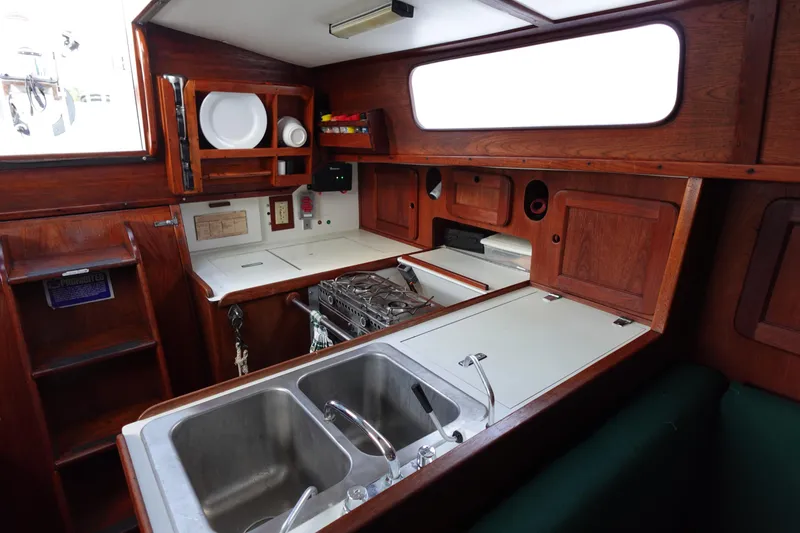 Slide: The Image of 1982 Morgan 383 yacht kitchen with wooden cabinetry and dual sinks. - 23