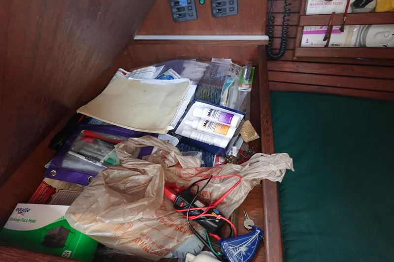 Slide: The Image of Drawer with assorted items in a 1982 Morgan 383 sailboat cabin. - 27