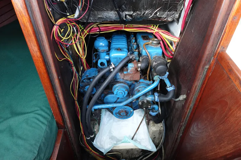 Slide: The Image of 1982 Morgan 383 engine compartment with blue engine and wiring. - 28