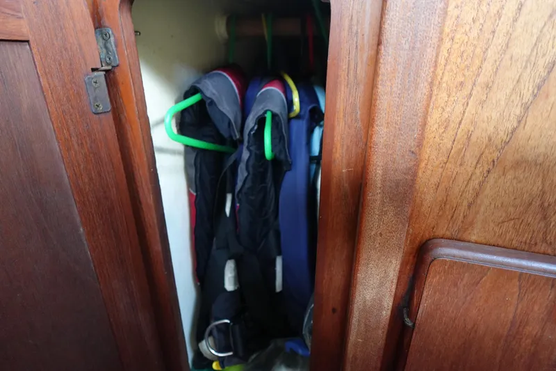 Slide: The Image of Wooden closet in 1982 Morgan 383 yacht with hanging jackets. - 31