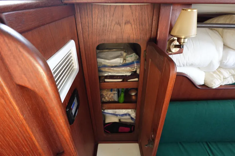 Slide: The Image of 1982 Morgan 383 yacht interior with wooden cabinet and storage shelves. - 39