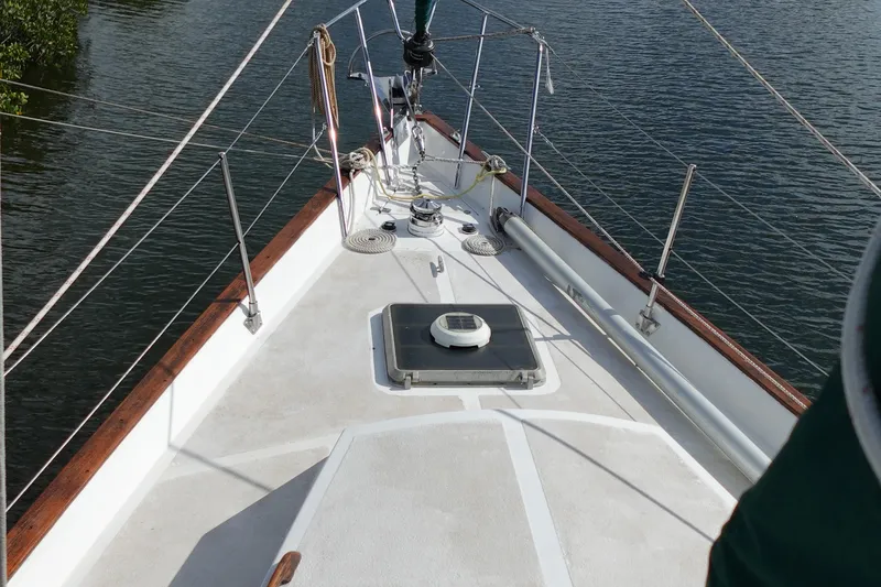 Slide: The Image of 1982 Morgan 383 sailboat deck with rigging, on calm water. - 6