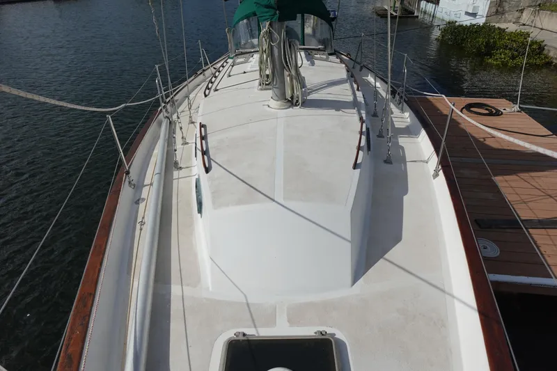 Slide: The Image of 1982 Morgan 383 sailboat deck view, docked by the water. - 9