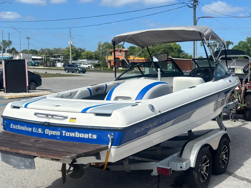 Slide: The Image of 2001 Malibu Response LX boat on trailer, parked outdoors under clear sky. - 10