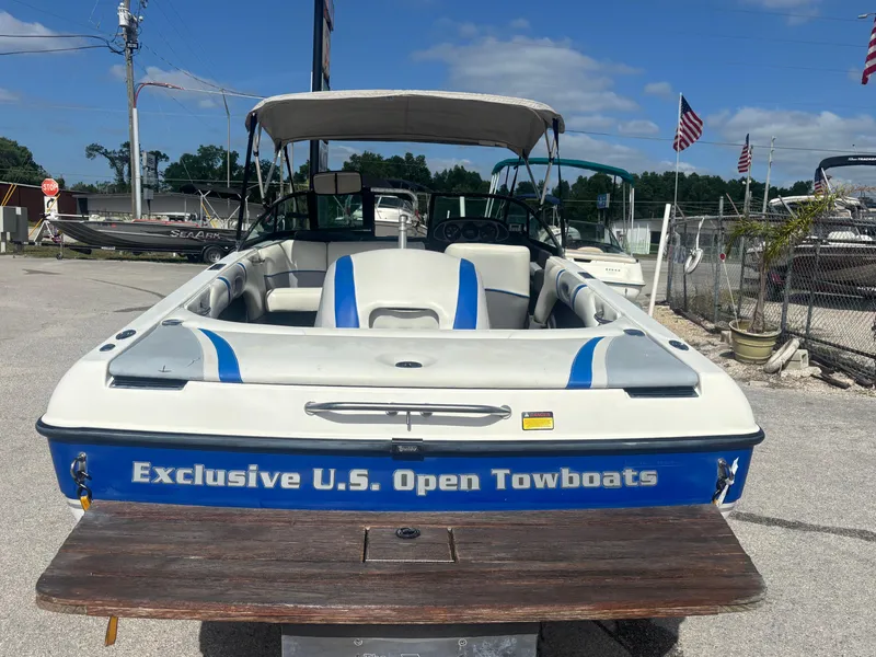 Slide: The Image of 2001 Malibu Response LX boat with "Exclusive U.S. Open Towboats" branding, parked outdoors. - 12