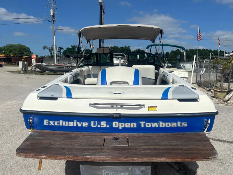 Slide: The Image of 2001 Malibu Response LX boat with "Exclusive U.S. Open Towboats" branding, parked outdoors. - 13