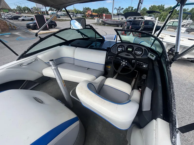 Slide: The Image of 2001 Malibu Response LX boat interior with white seating and dashboard controls. - 16