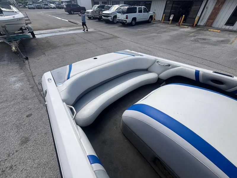 Slide: The Image of 2001 Malibu Response LX boat interior with blue and white seating in a parking lot. - 20