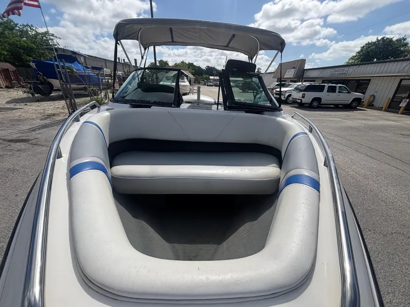 Slide: The Image of 2001 Malibu Response LX boat with seating, docked under a cloudy sky. - 22