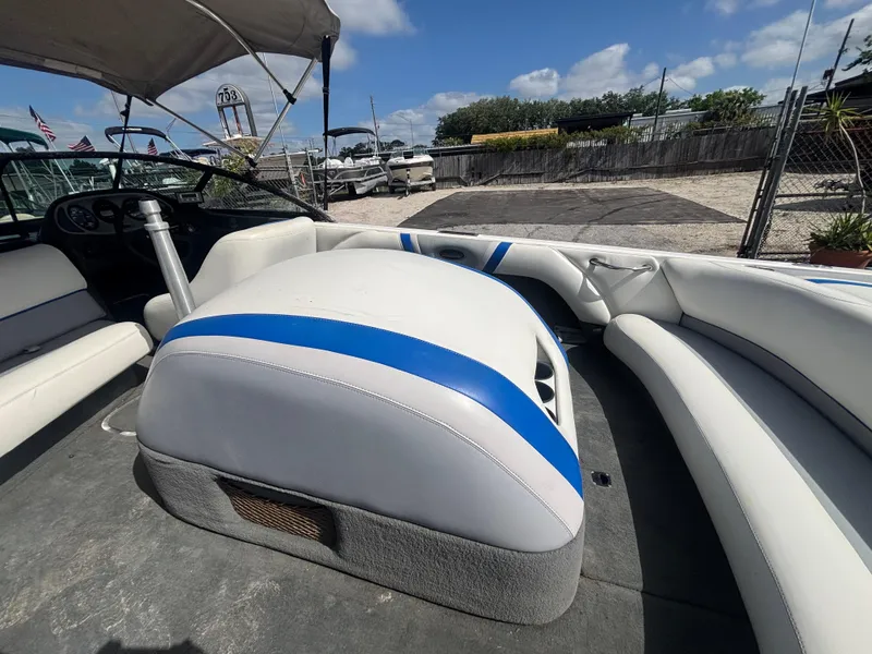 Slide: The Image of 2001 Malibu Response LX boat interior with white and blue seating under a sunny sky. - 26