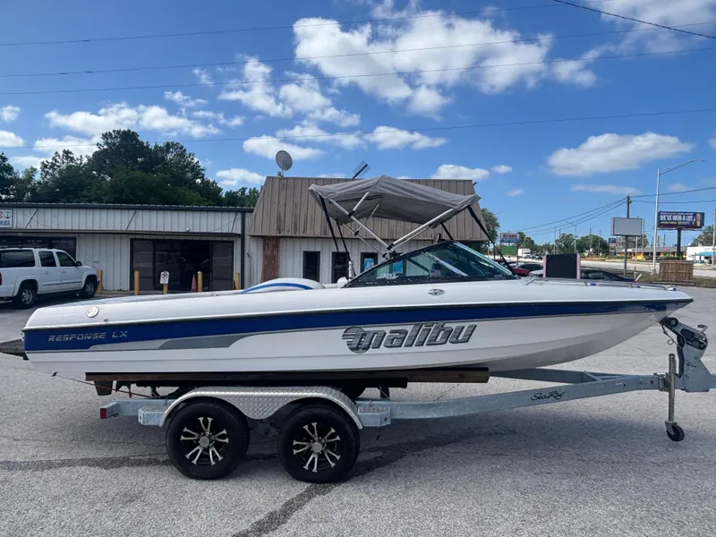 Slide: The Image of 2001 Malibu Response LX boat on trailer, parked outdoors under a clear blue sky. - 3