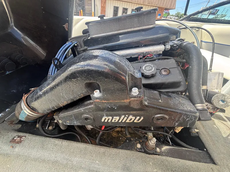 Slide: The Image of 2001 Malibu Response LX engine compartment with visible components and branding. - 31