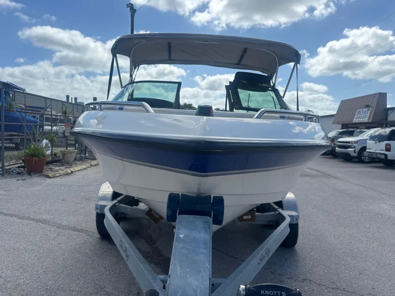 Slide: The Image of 2001 Malibu Response LX boat on trailer under a cloudy sky. - 5