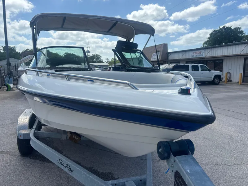 Slide: The Image of 2001 Malibu Response LX boat on trailer, parked outdoors under a partly cloudy sky. - 7