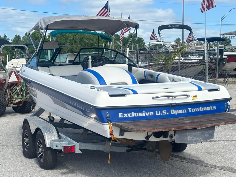 Slide: The Image of 2001 Malibu Response LX boat on trailer with American flags in background. - 8