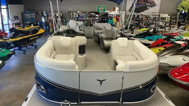 Slide: The Image of 2025 Tahoe LTZ 2385 QLS pontoon boat in showroom with jet skis. - 3